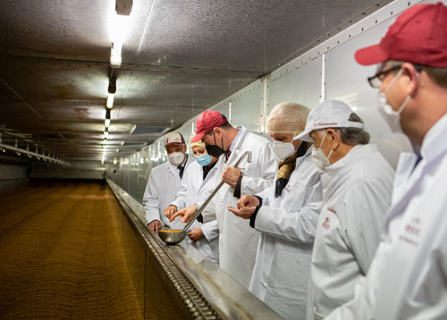 People standing at the germination/kiln-drying floor in the malthouse